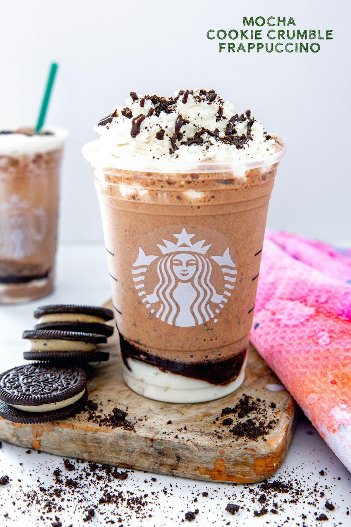 Head-on view of a Mocha Cookie Crumble Frappuccino in a Starbucks cup with Oreo cookies all around and recipe title at top.