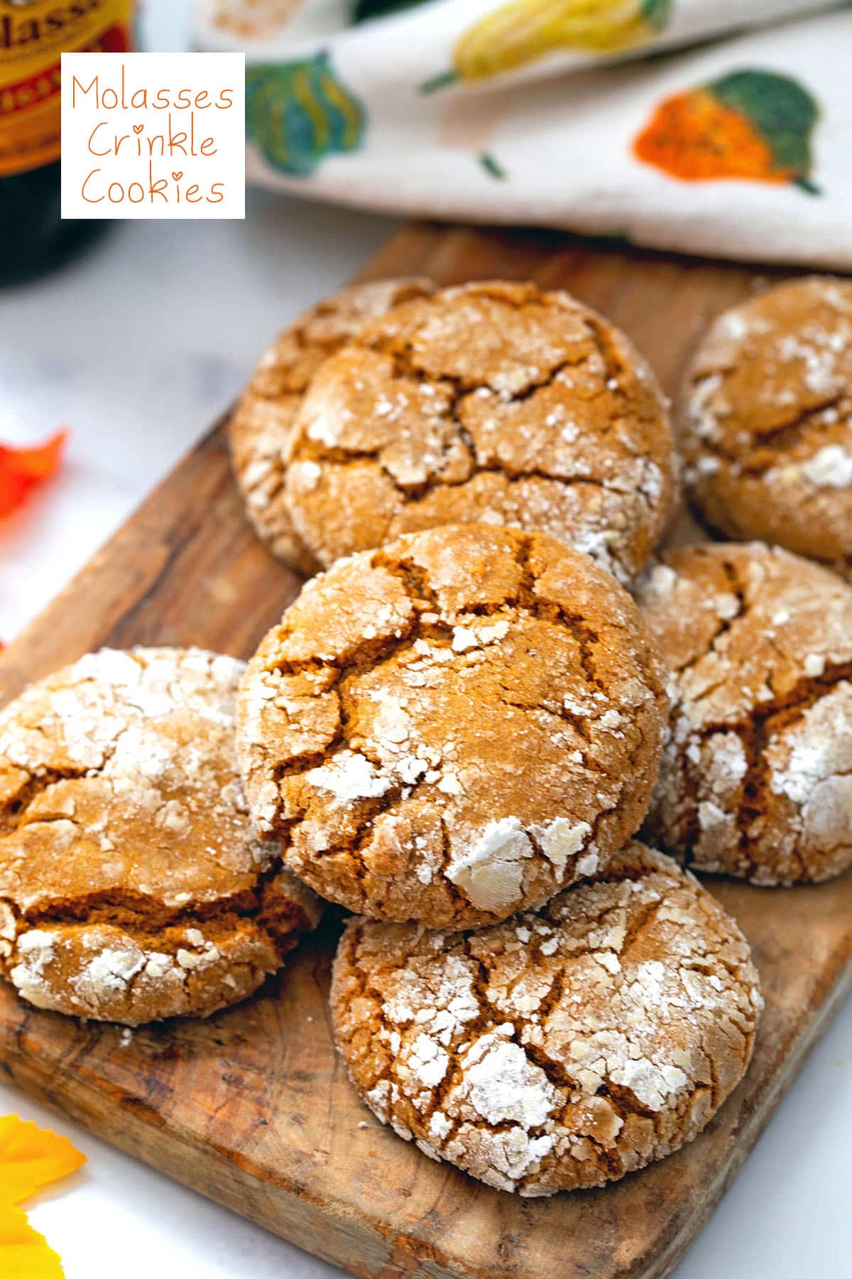 Molasses crinkle cookies on a wooden board with recipe title at top.