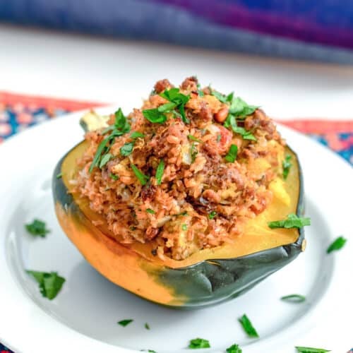 Closeup view of a Moroccan stuffed acorn squash with ground beef and bulgur.