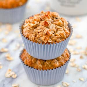 Closeup view of oatmeal raisin muffins stacked on each other.