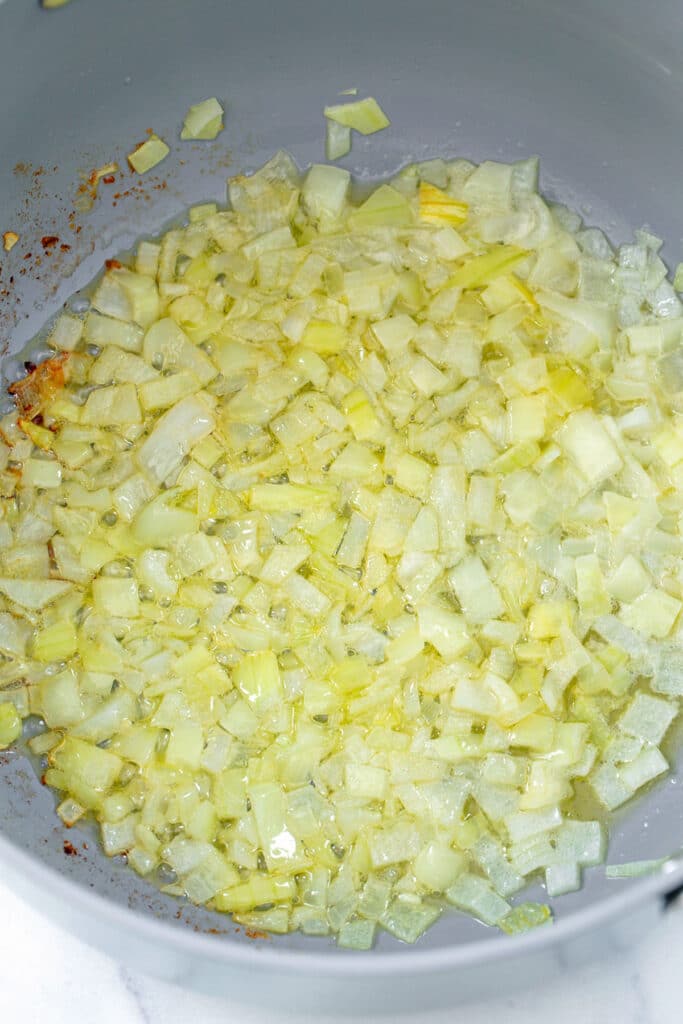 Onions cooking in butter in skillet.