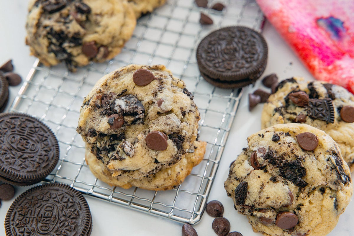 Overhead landscape view of Oreo chocolate chip cookies with Oreo cookies and chocolate chips all around.