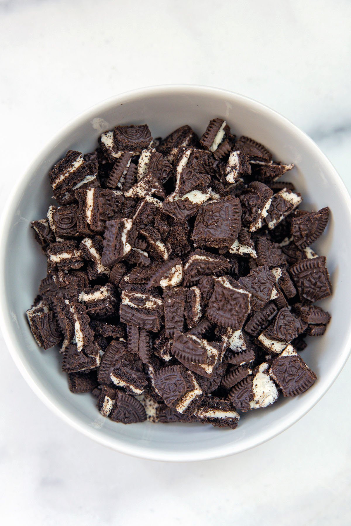 Chopped Oreo cookies in a bowl.