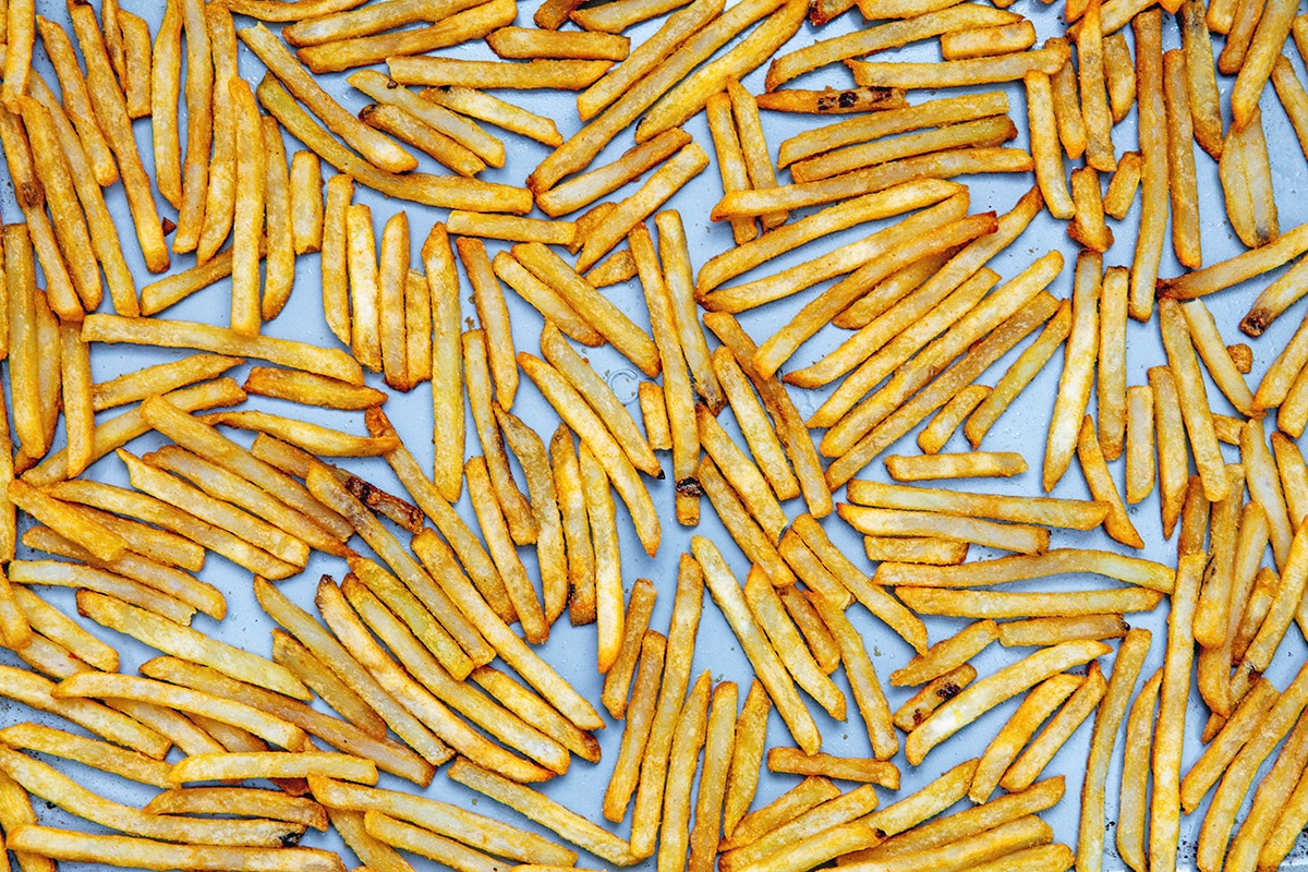 French fries in single layer on baking sheet.