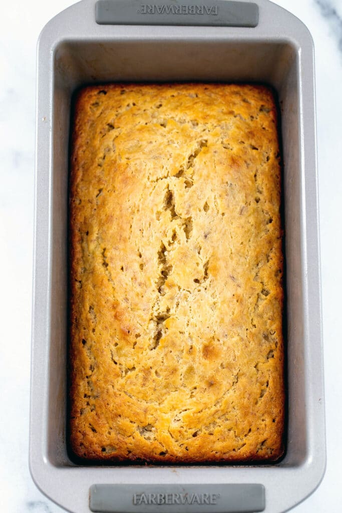 Banana bread in loaf pan just out of oven.