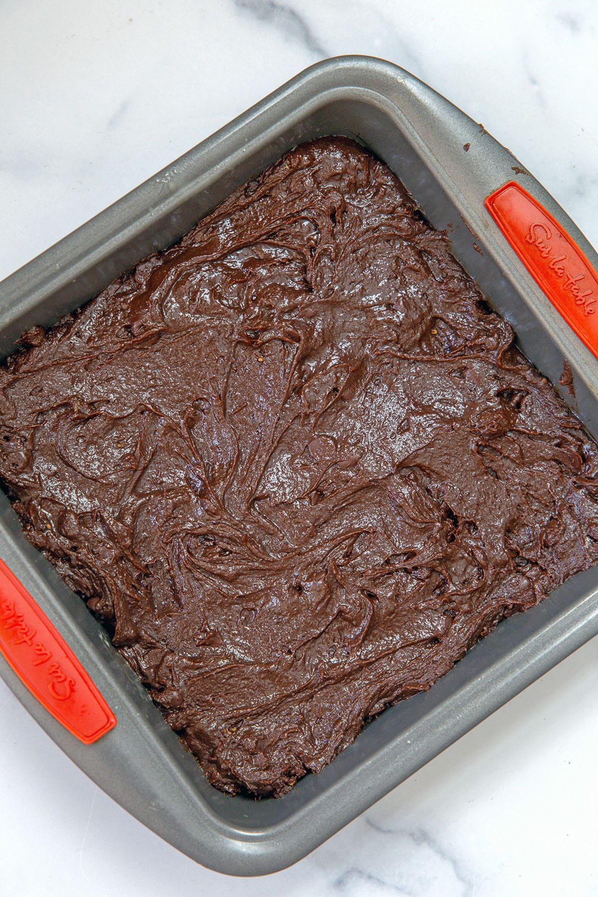 Overhead view of brownie batter spread in pan.