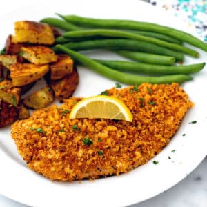 Panko crusted chicken breast topped with lemon and served with green beans and roasted potatoes.