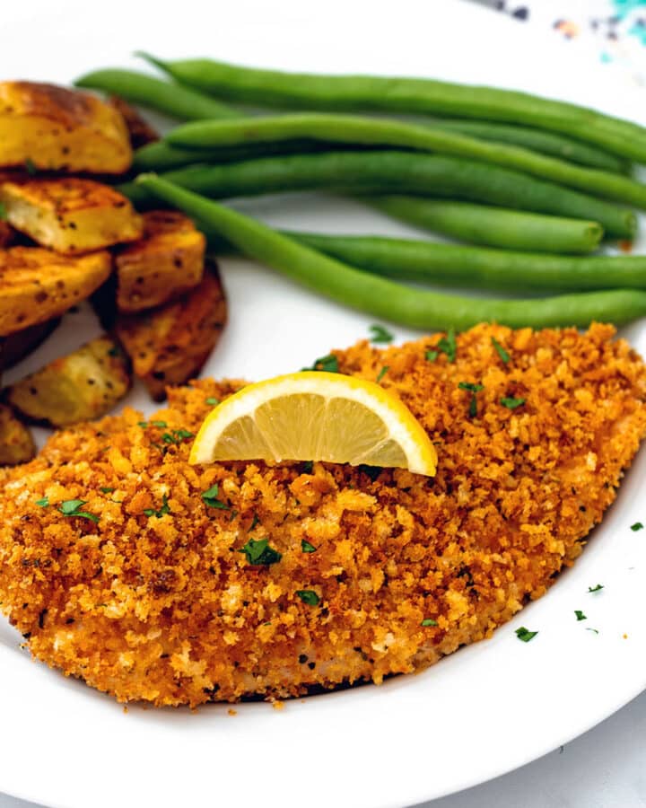 Panko crusted chicken breast topped with lemon and served with green beans and roasted potatoes.