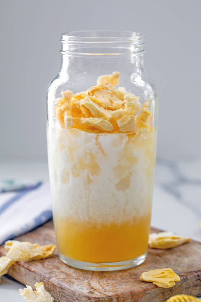 Pineapple passionfruit base with coconut milk and freeze-dried pineapple in a shaker.
