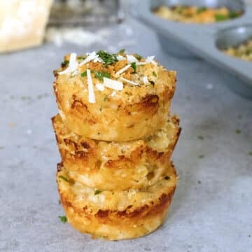 Closeup view of a stack of parmigiano reggiano mac and cheese bites.