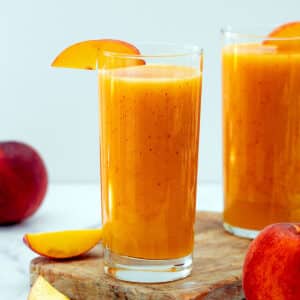 Close-up view of a glass of peach juice.