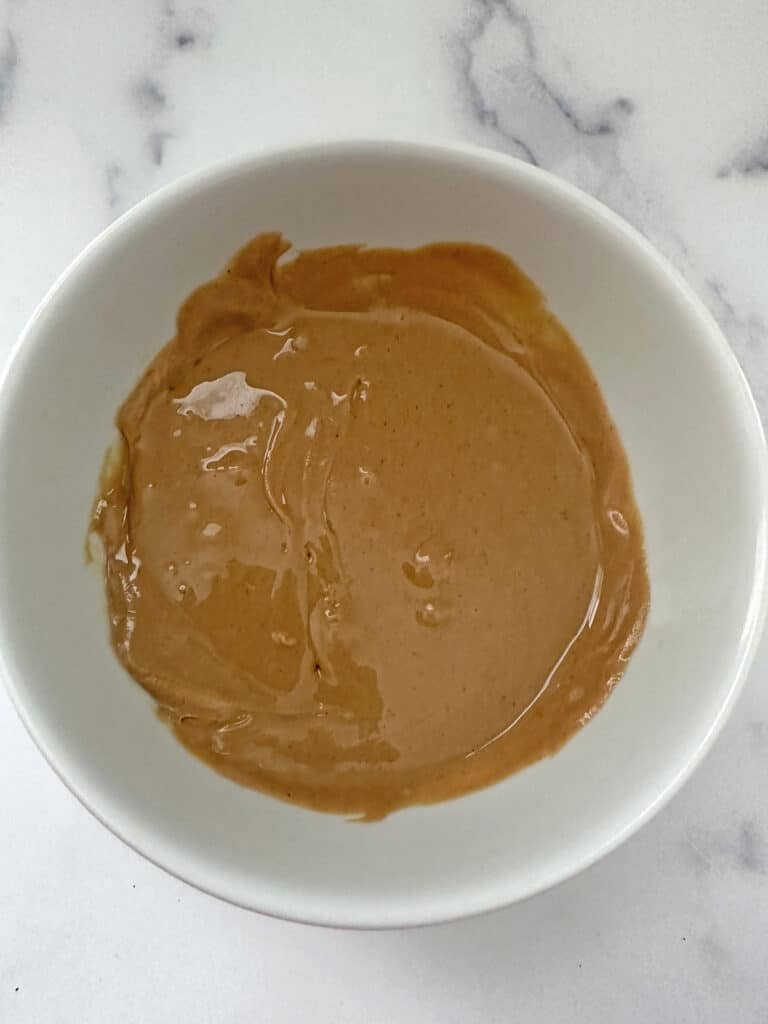 Warmed peanut butter sauce in a bowl.