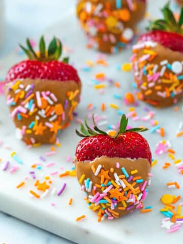 Peanut butter strawberries with sprinkles.