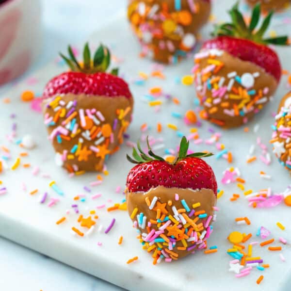Peanut butter strawberries with sprinkles.