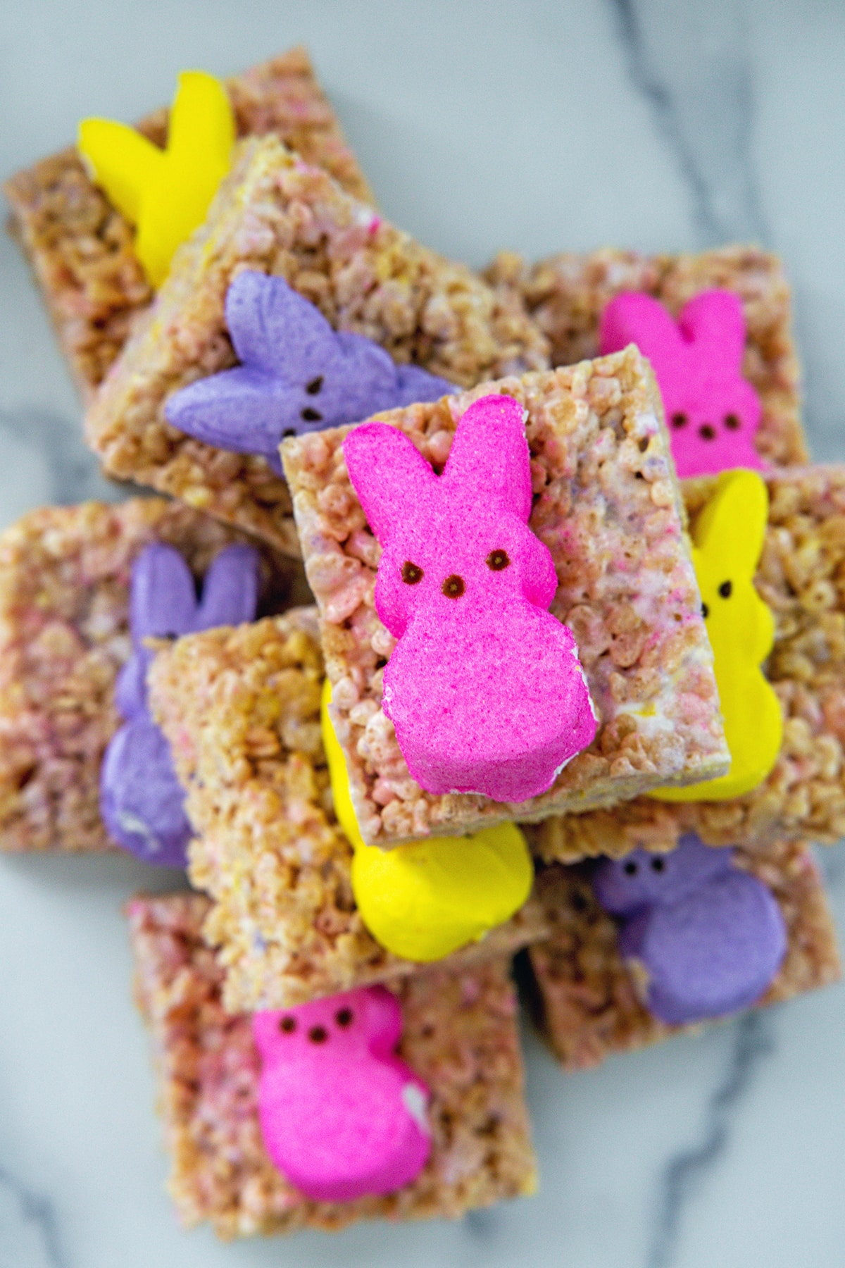 Stack of Peeps Rice Krispies treats squares with marshmallow bunnies.