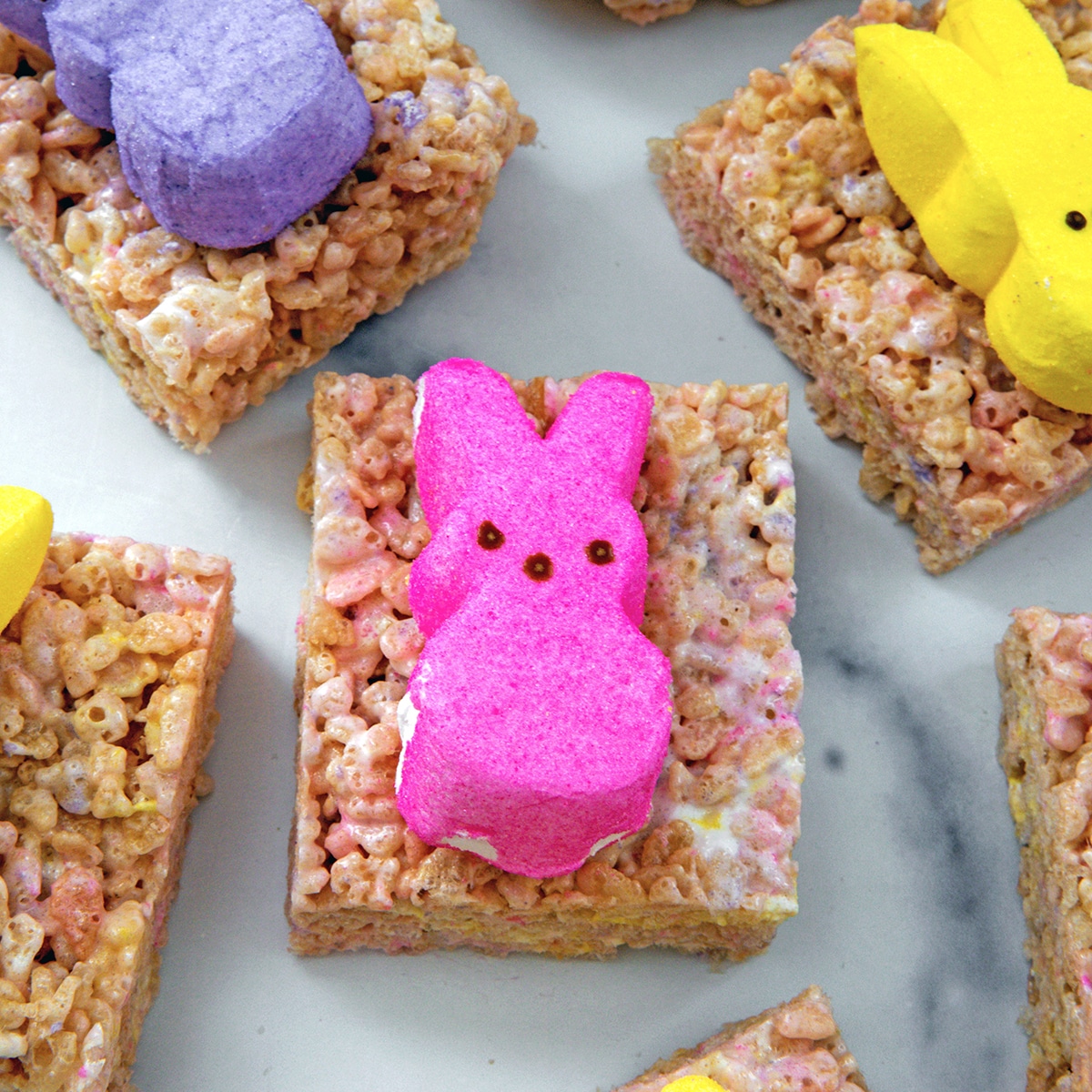 Overhead closeup view of a colorful Rice Krispies treat with pink Peeps bunny on top.