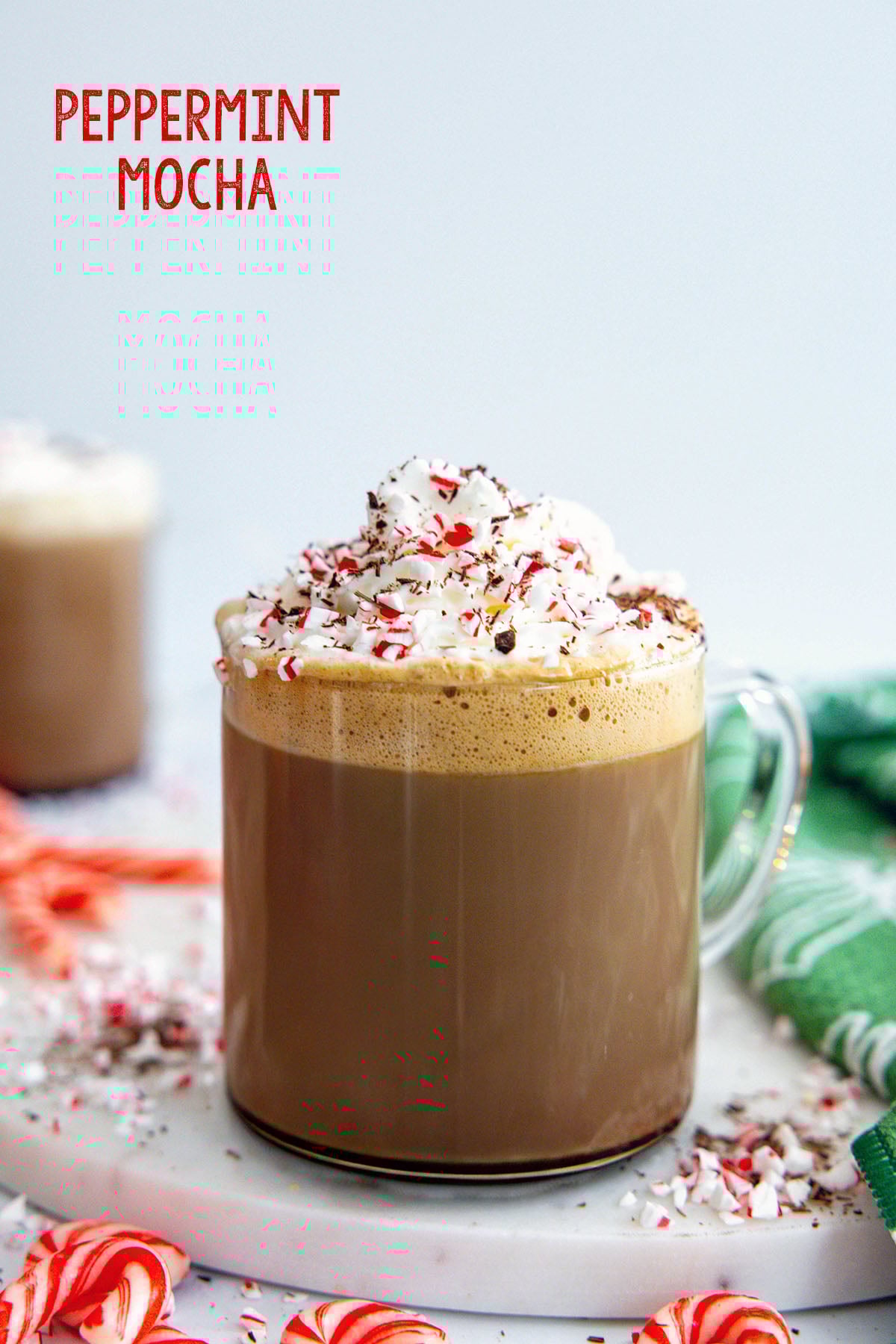 Head-on view of a Starbucks Peppermint Mocha with whipped cream, candy cane pieces, and recipe title at top.