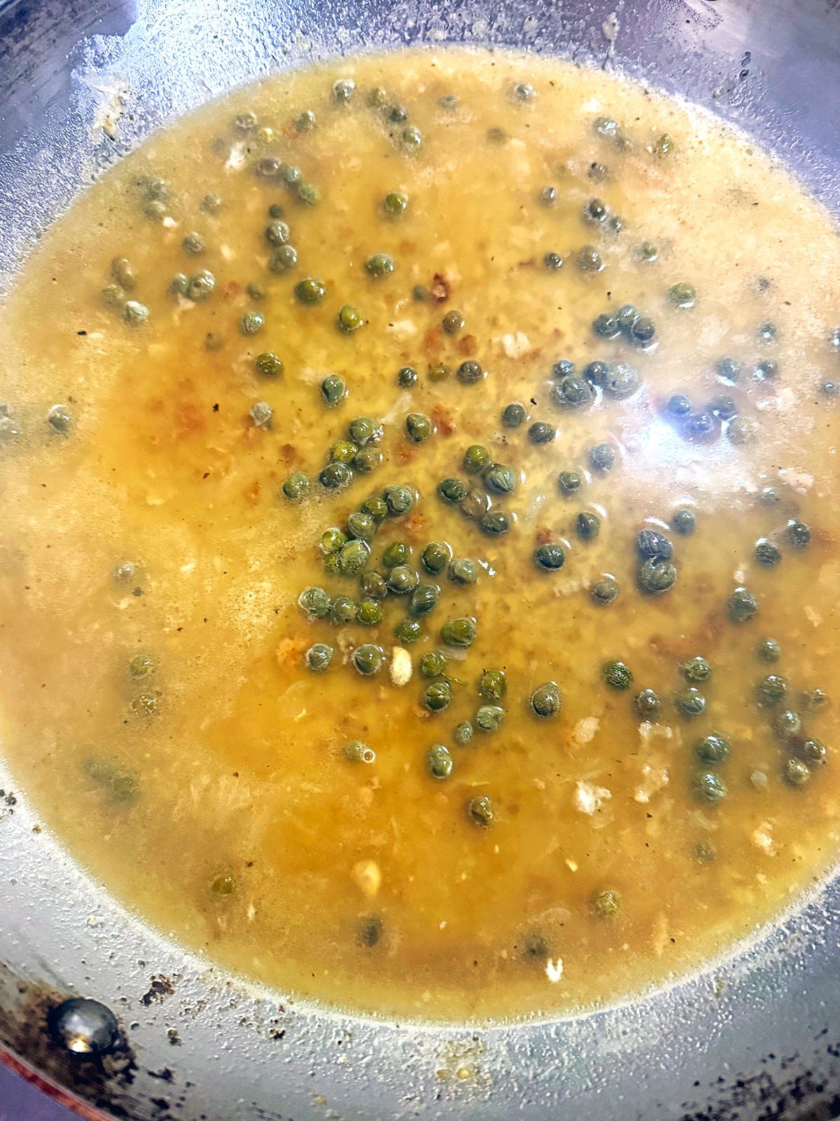 Piccata sauce with capers and red pepper flakes.