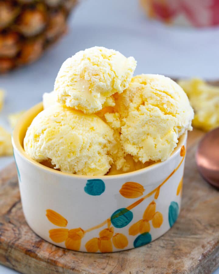 Closeup view of small bowl of pineapple ice cream.