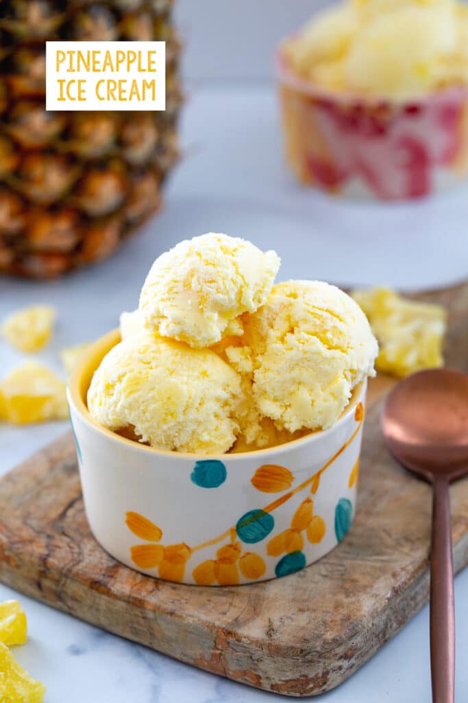 Small bowl of pineapple ice cream with fresh pineapple and dried fruit in background and recipe title at top.