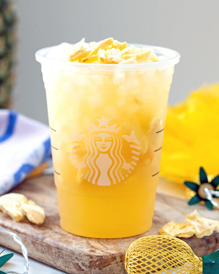 Head-on view of pineapple passionfruit refresher in Starbucks cup.