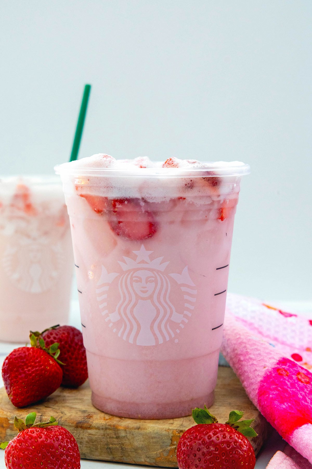 Head-on view of easy 3-ingredient Pink Drink with strawberries all around.