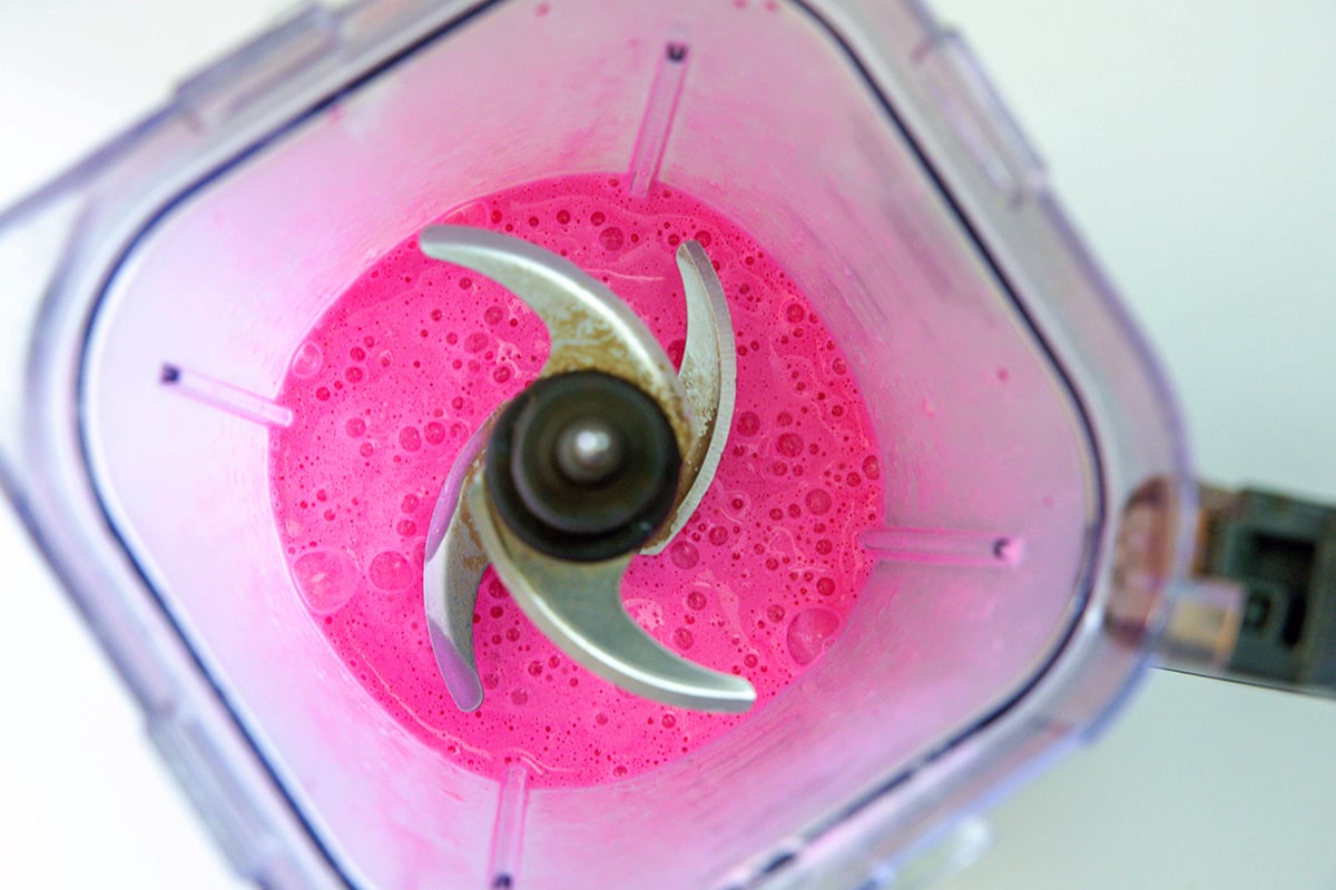 Bright pink Frappuccino mixture in blender.