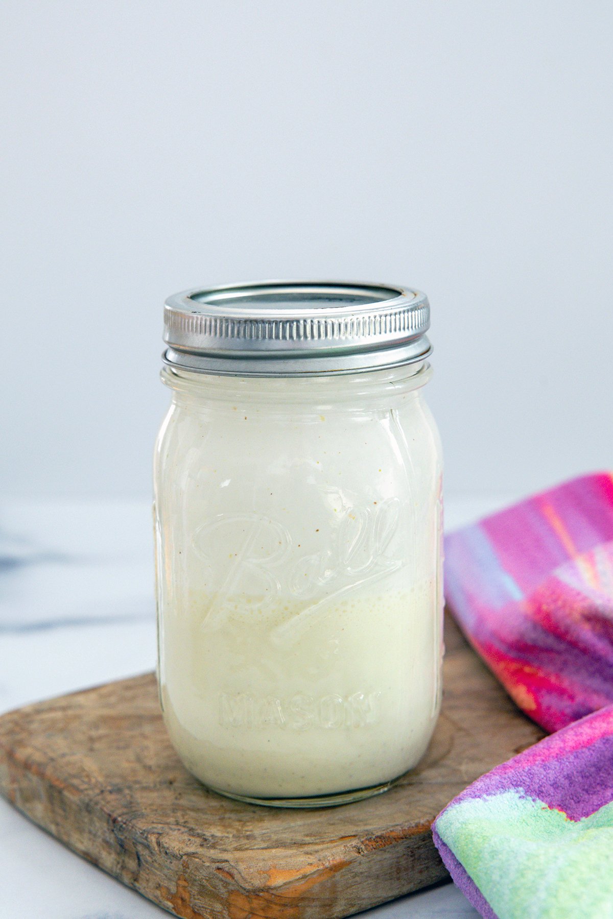 Head-on view of pistachio cold cream in a mason jar.