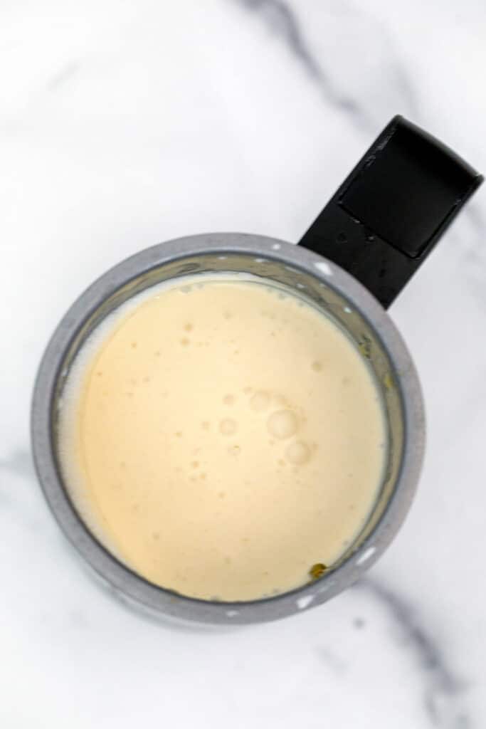 Pistachio cream cold foam in milk frother.
