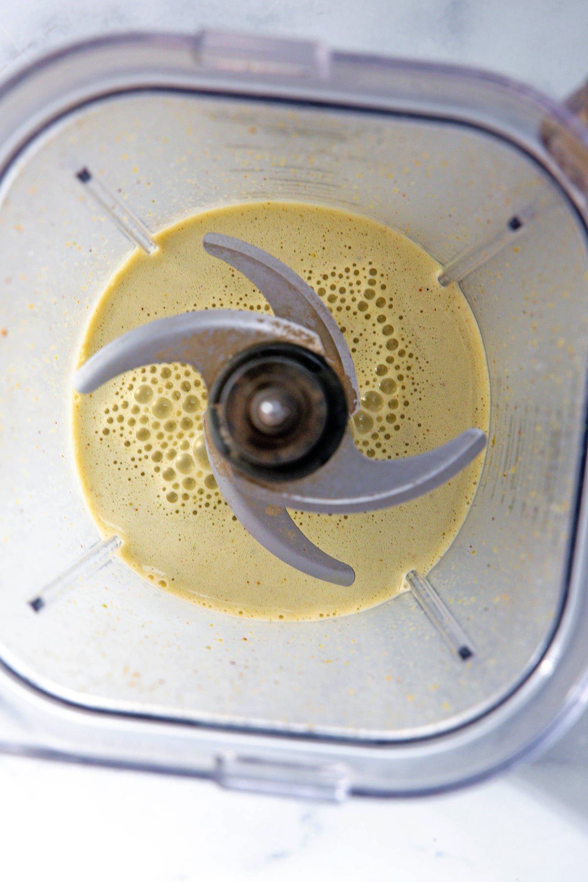 Overhead view of pistachio sauce in blender.