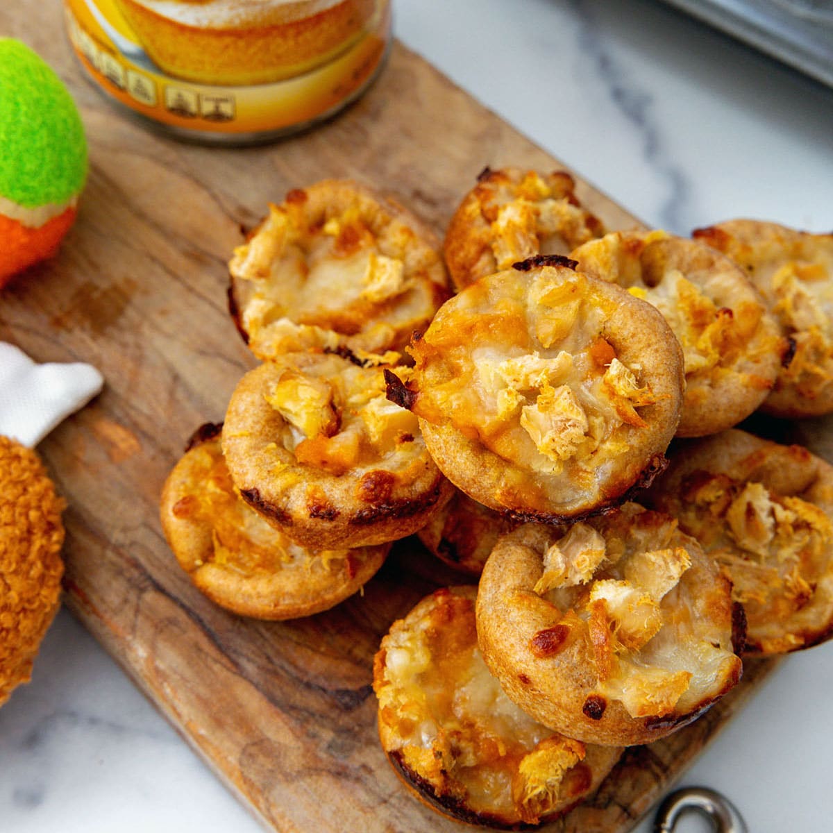 Closeup view of mini pizza for dogs topped with chicken.