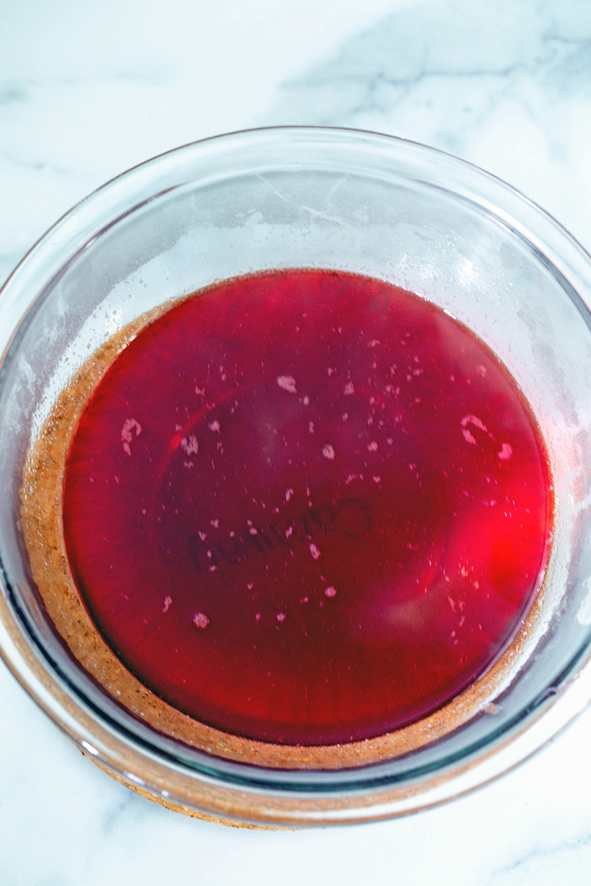 Prickly pear syrup strained into bowl.