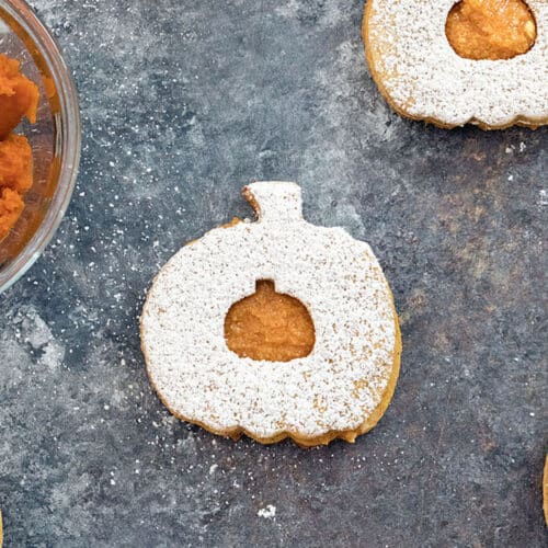 Closeup view of a pumpkin linzer cookie.