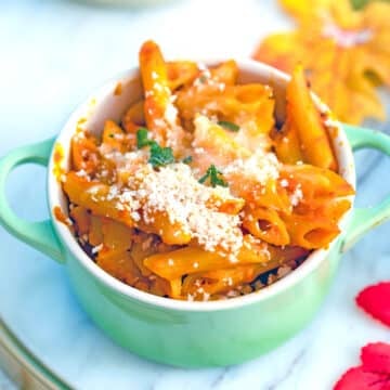 Closeup view of a small ramekin of pumpkin mac and cheese.