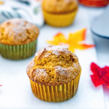 Head-on closeup view of a pumpkin muffin with cake mix topped with cinnamon sugar.