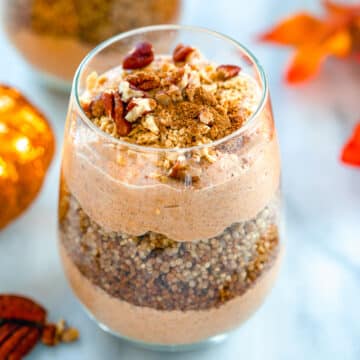 Closeup view of a pumpkin quinoa parfait with chopped pecans on top.
