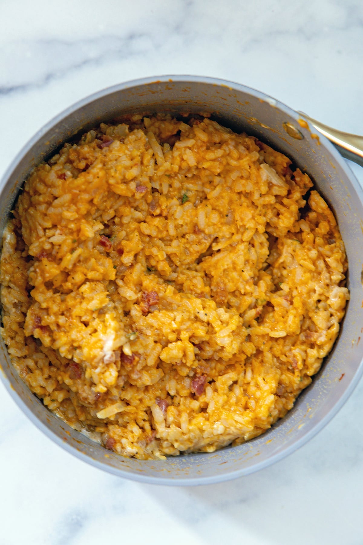 Overhead view of pumpkin risotto in a saucepan.