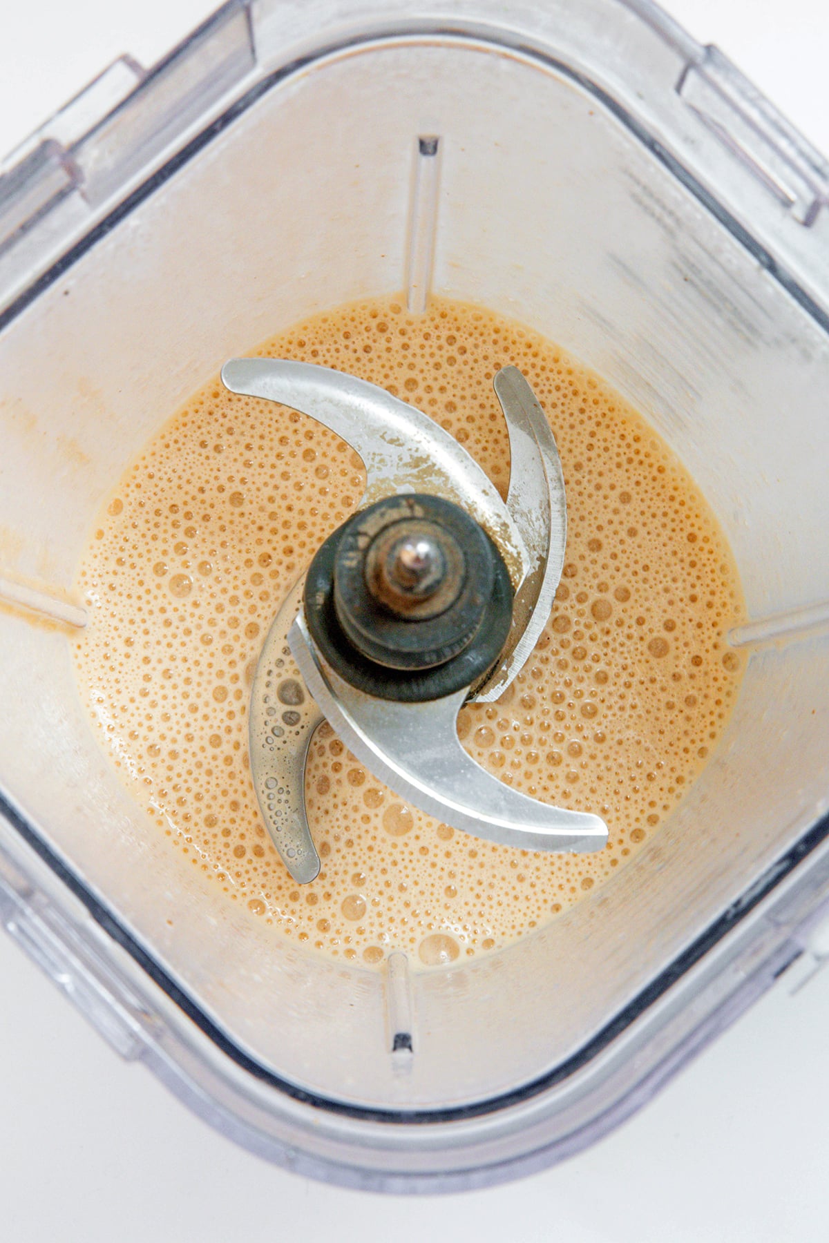 Overhead view of blended Pumpkin Spice Frappuccino in blender.