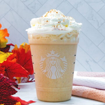 Closeup head-on view of a Pumpkin Spice Frappuccino with whipped cream.