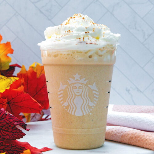 Closeup head-on view of a Pumpkin Spice Frappuccino with whipped cream.