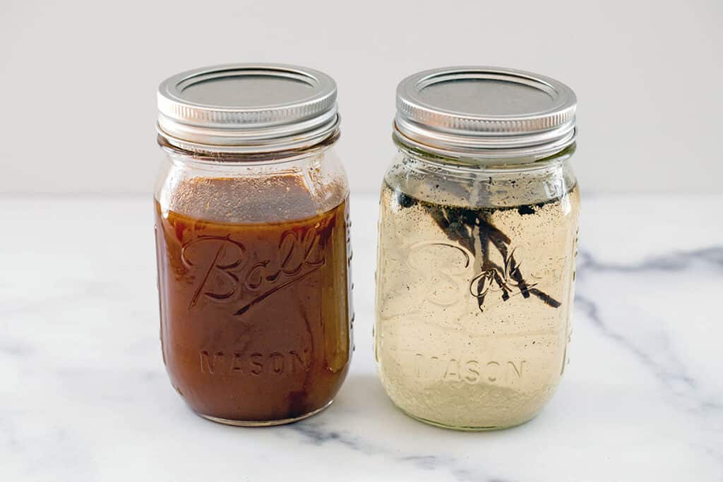 Mason jars of pumpkin spice sauce and vanilla syrup.