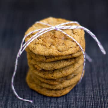 Closeup view of a stack of pumpkin toffee gingersnaps tied together with a string.