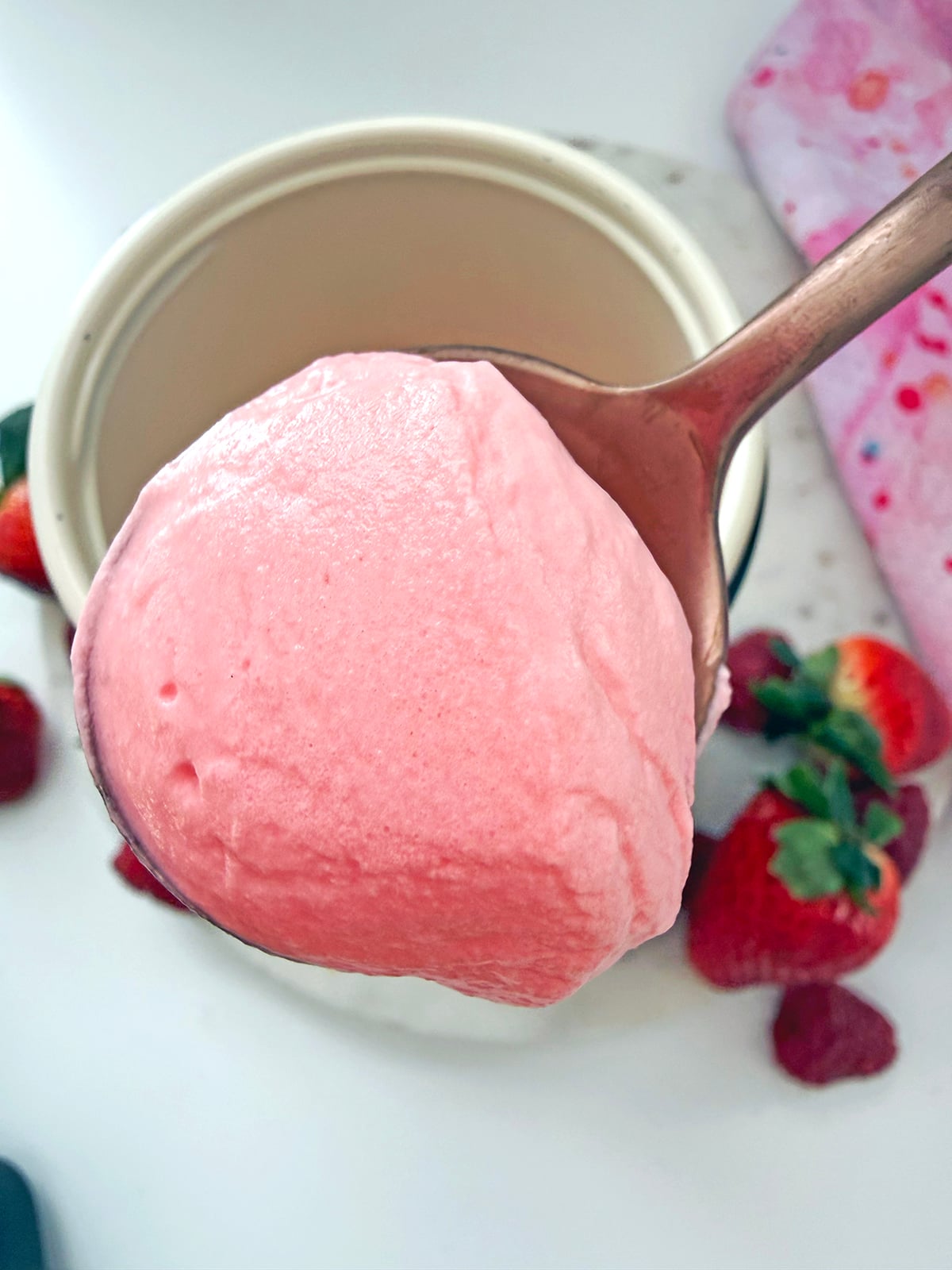 Raspberry cream cold foam on spoon.