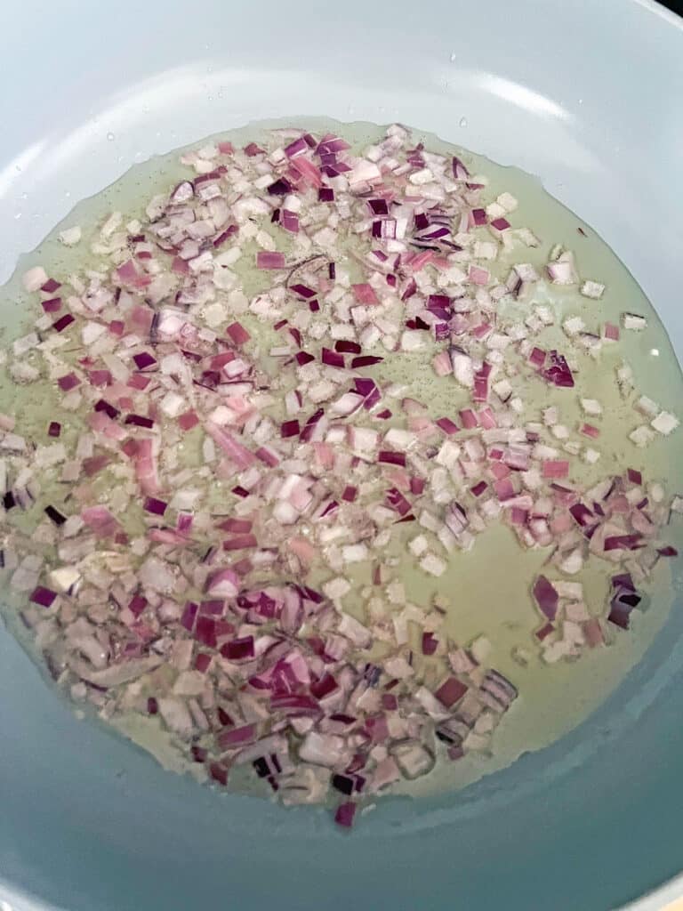 Red onion cooking in olive oil.