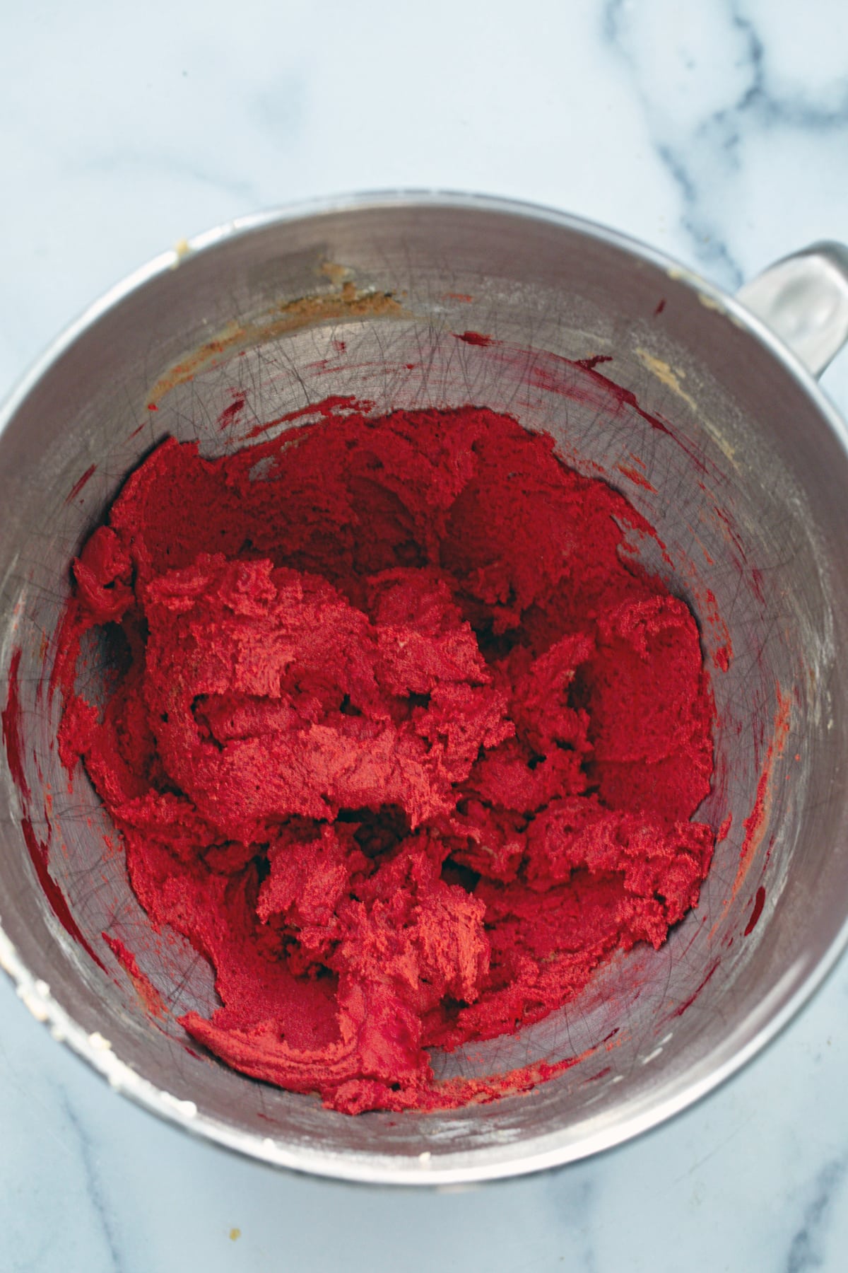 Red velvet cookie dough in mixing bowl.