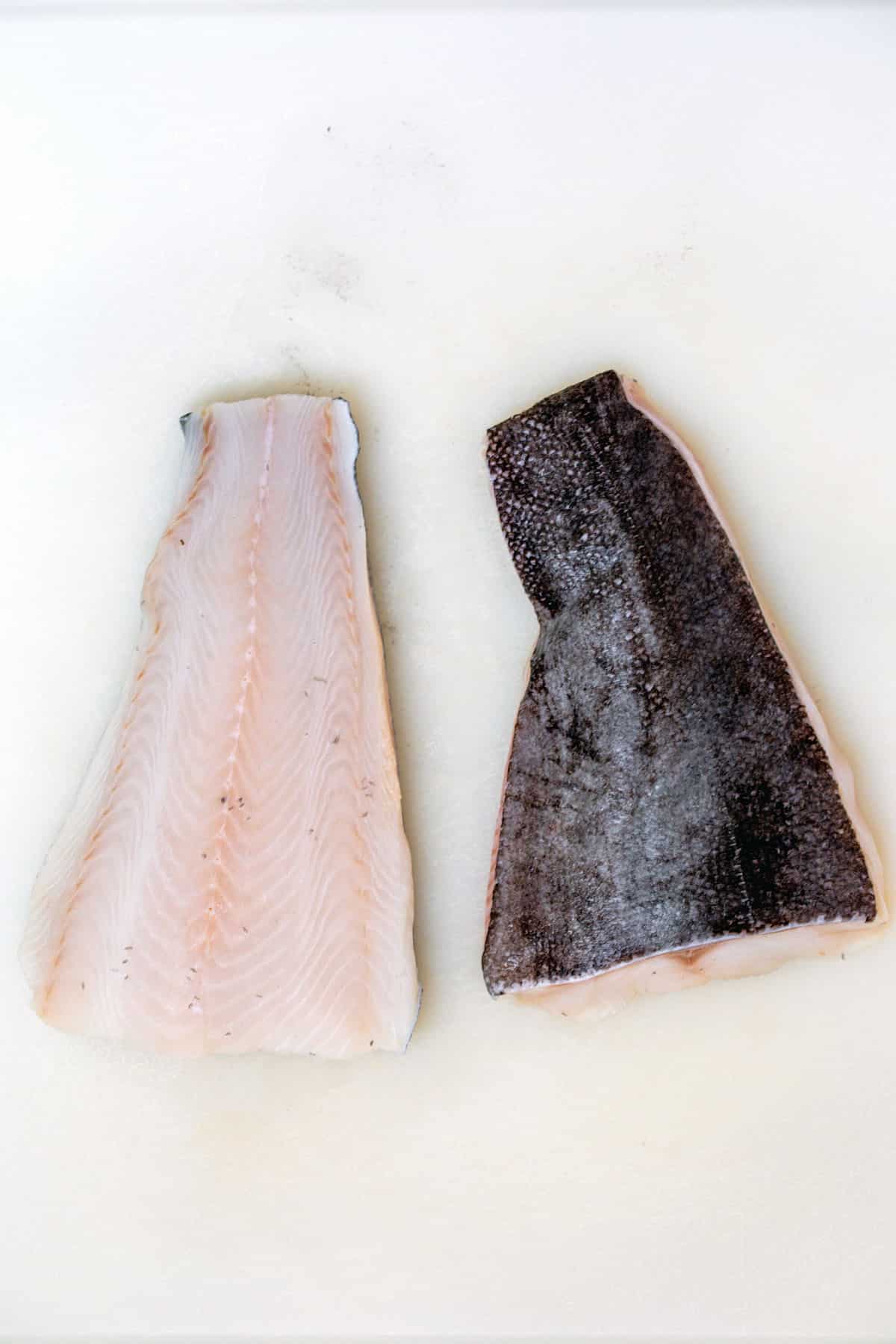 Sablefish fillets on a cutting board.