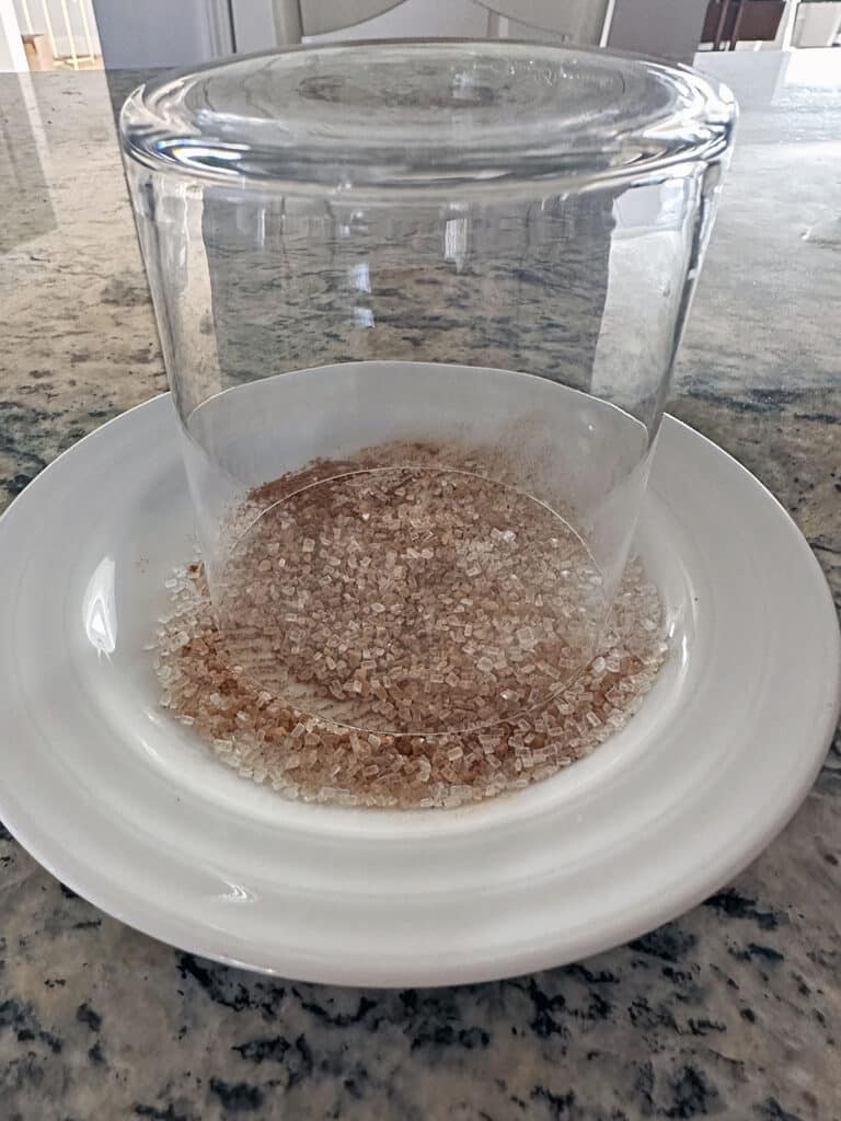 Glass upside-down on small plate with salt, sugar, and cinnamon mixture.