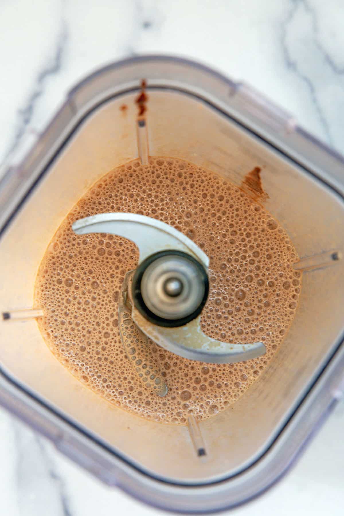 Overhead view of mocha Frappuccino blended in blender.
