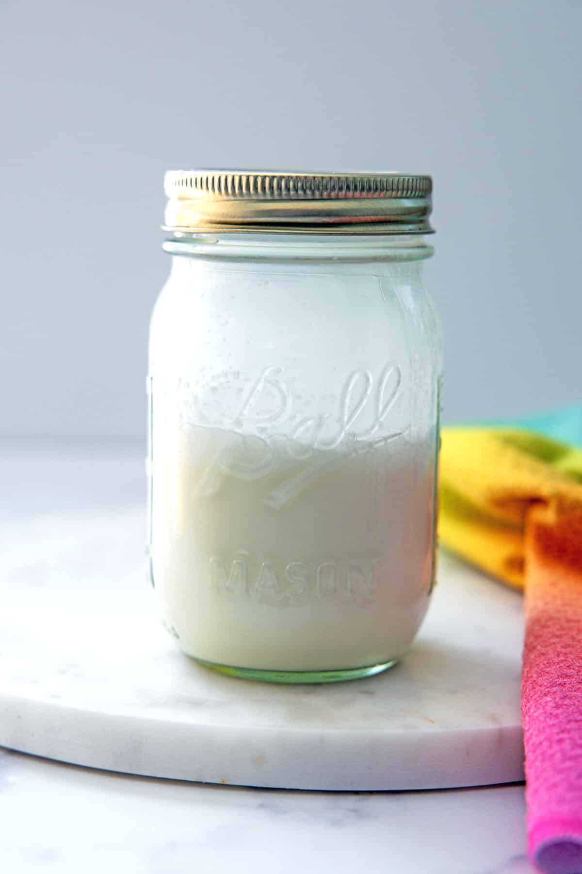 Head-on view of a mason jar of salted caramel cold cream.