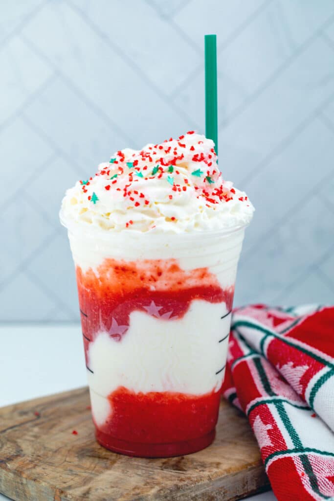 Santa Claus Frappuccino with whipped cream and red and green sprinkles.